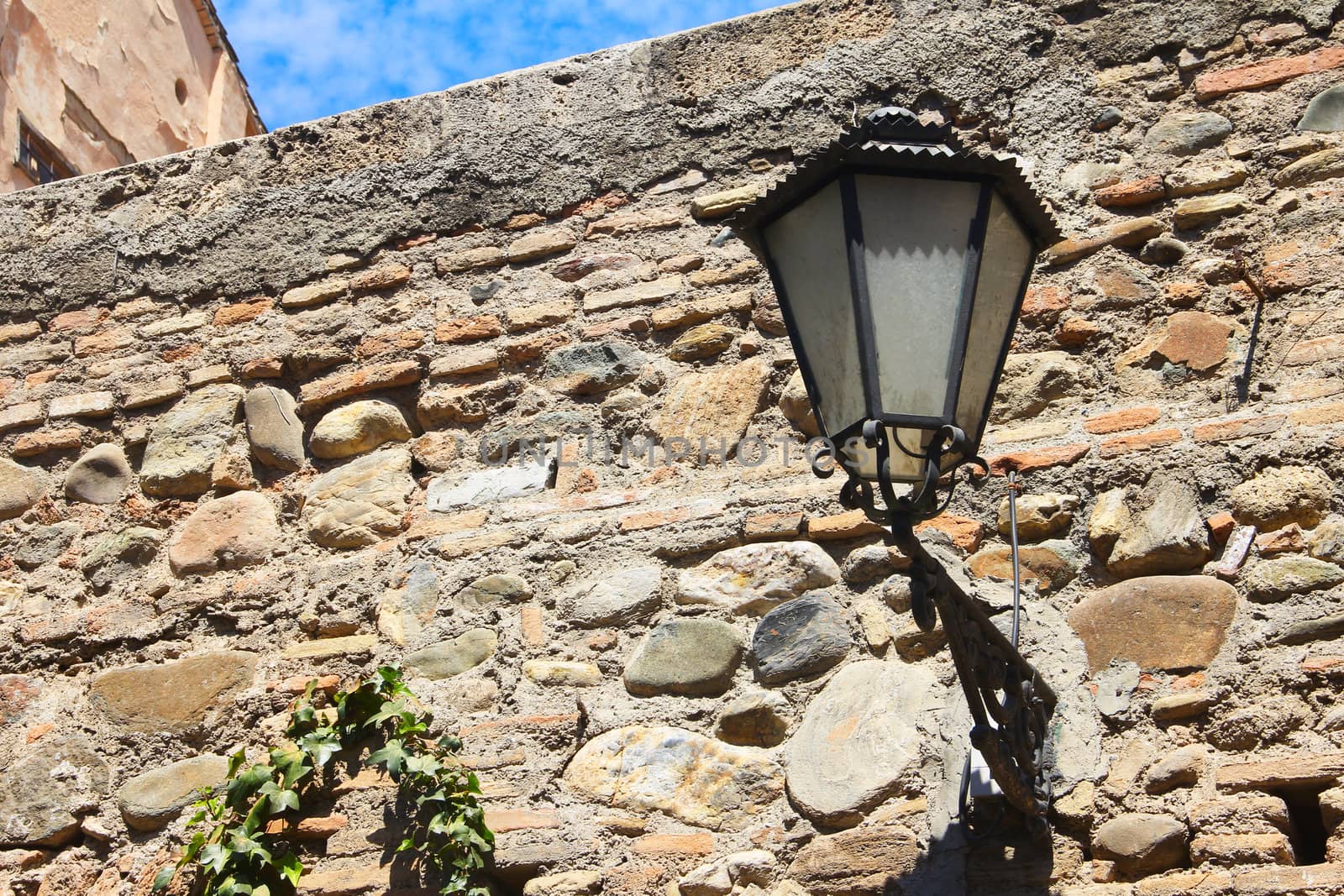 Old lantern and ancient wall in Alhambra