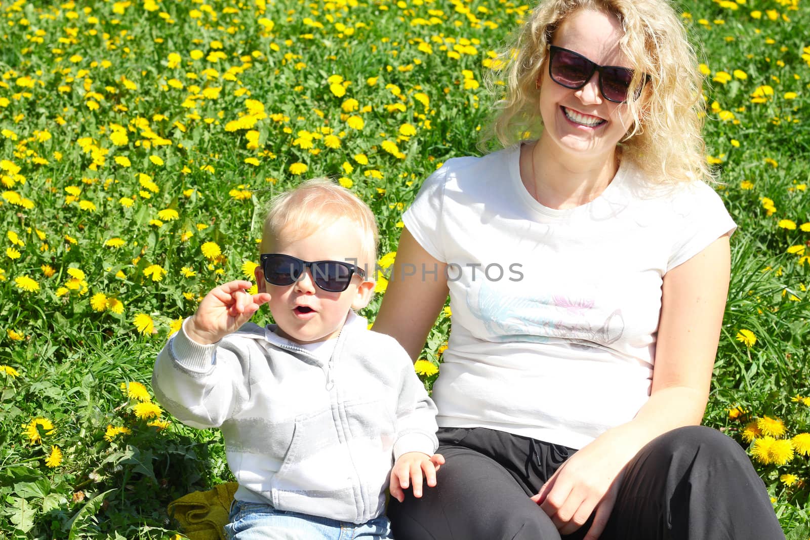 Funny mother and child wearing similar sunglasses