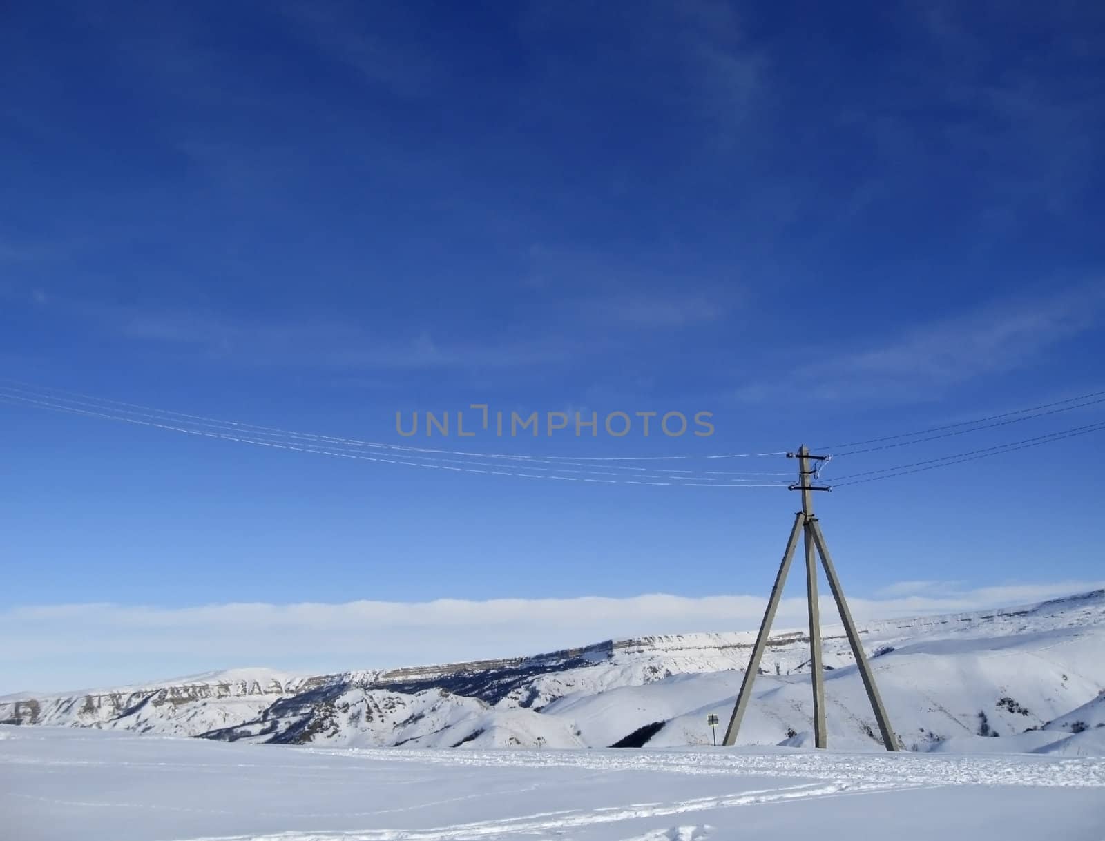Blue sky with a little clouds and winter caucasus mountain landscape
