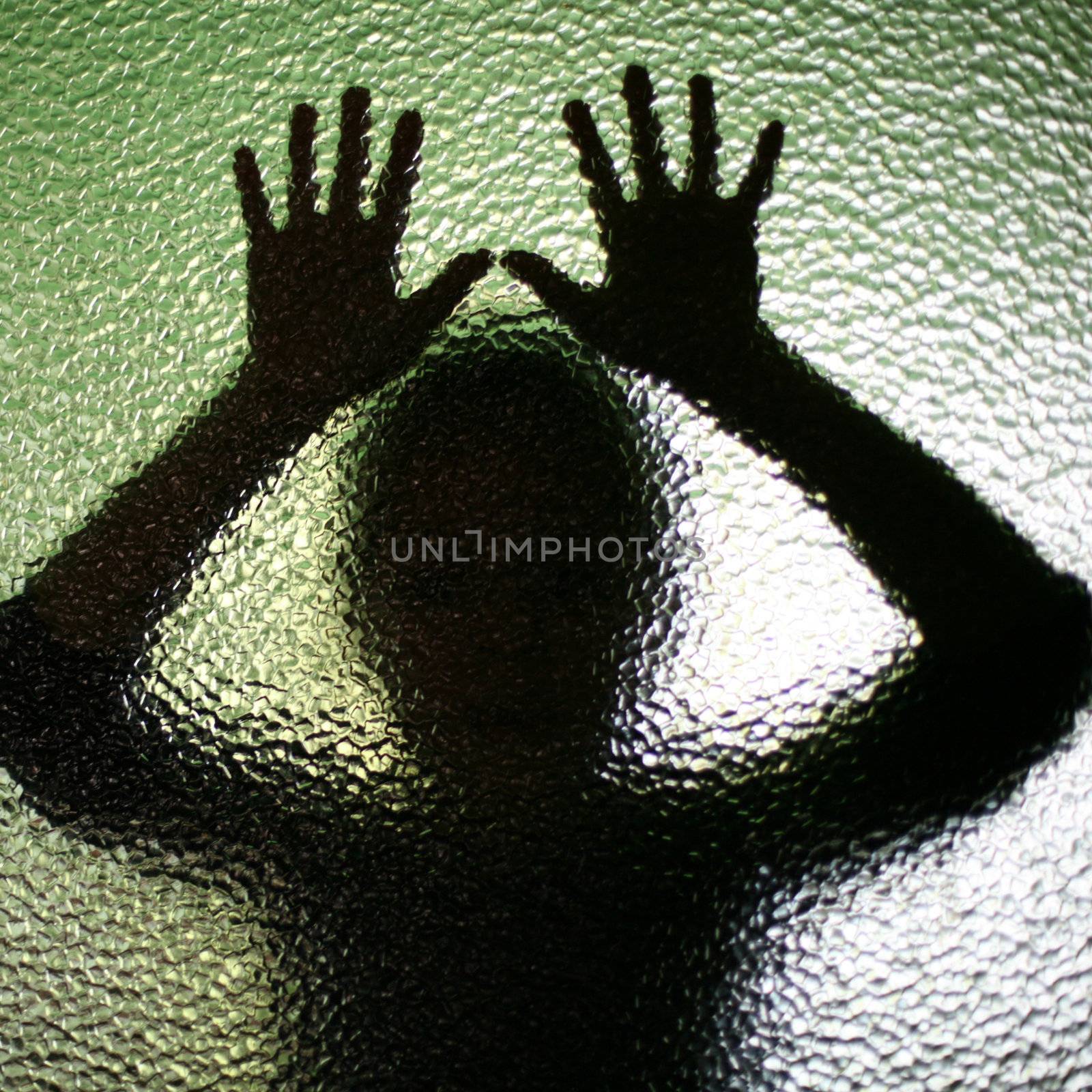 An image of a silhouette behind glass