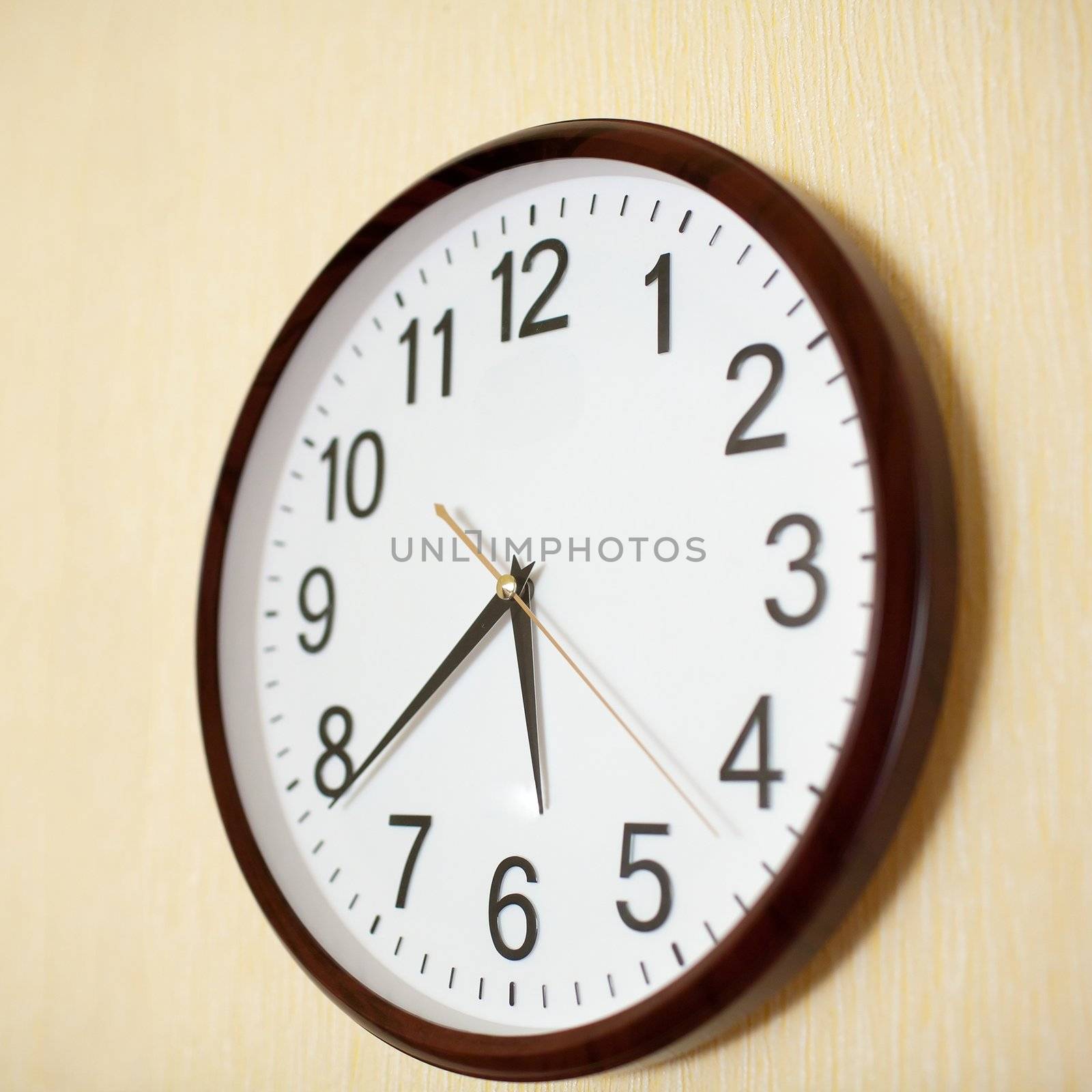 An image of a clock on yellow wall