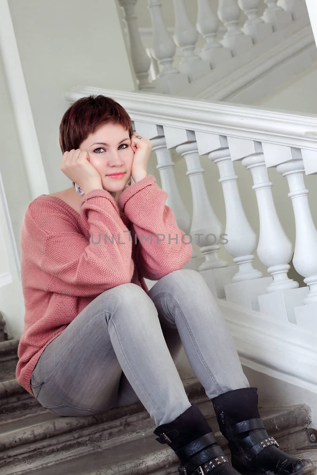 Portrait of a young beautiful woman on ladder