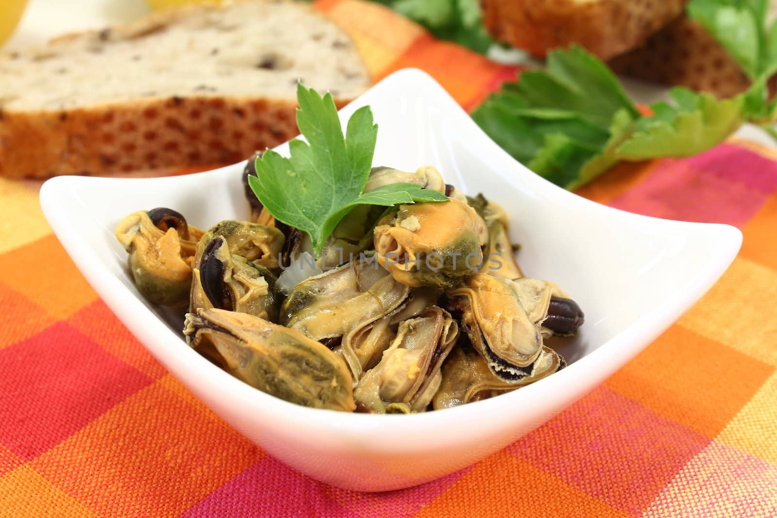 a bowl of marinated mussels and parsley