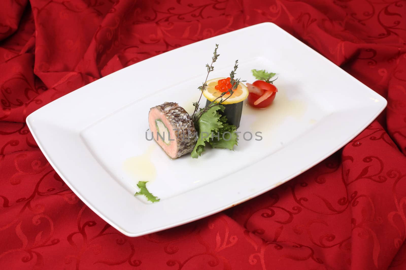 Stuffed fish with vegetables on white plate
