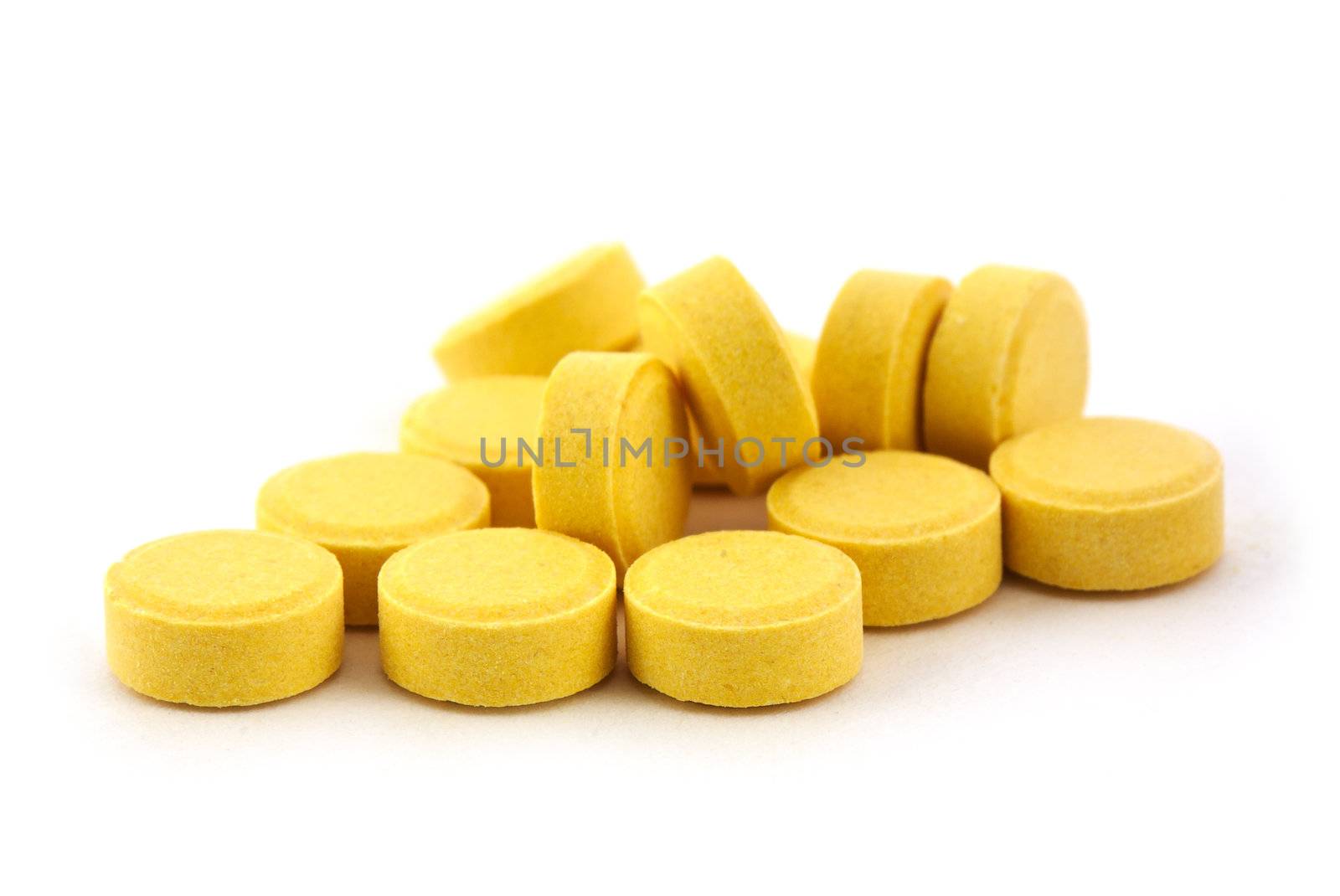 Yelow pills isolated on white