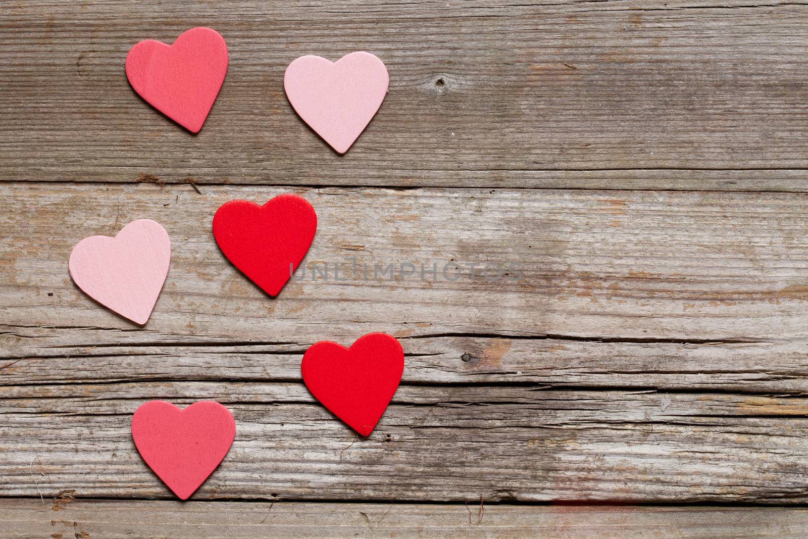 red hearts on rustic wood with copy space 