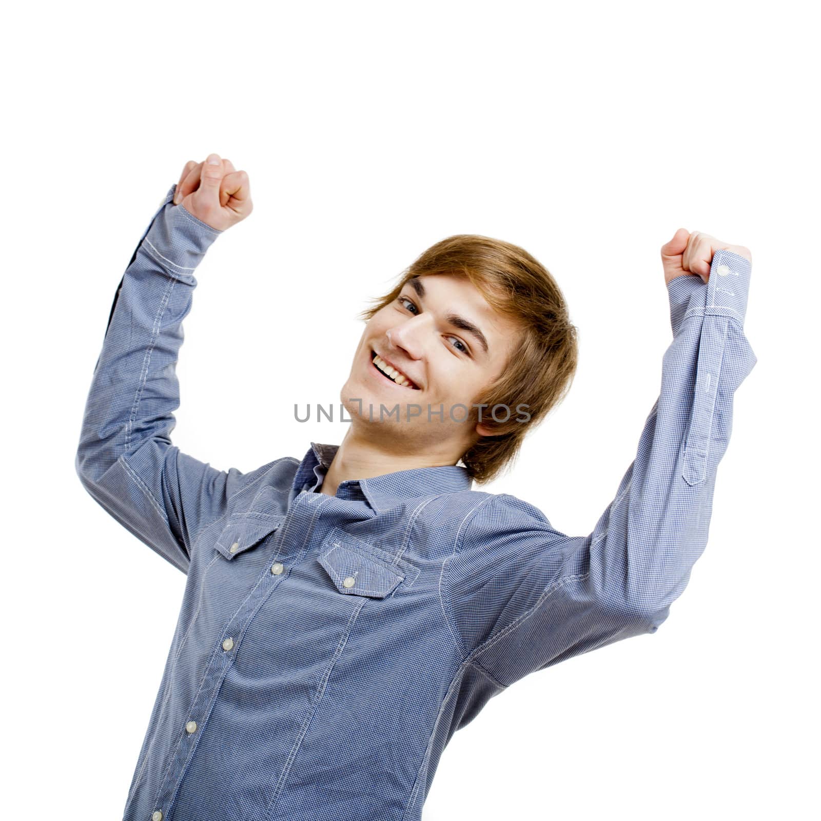 Happy young man with arms raised in the air, isolated on white background