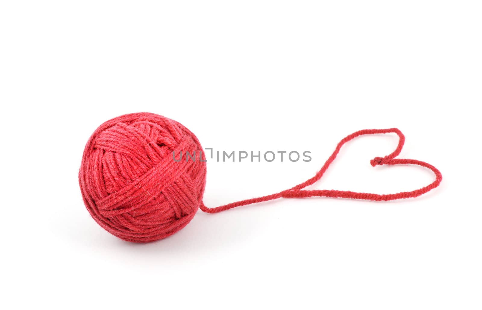 Thread ball with heart isolated on white background