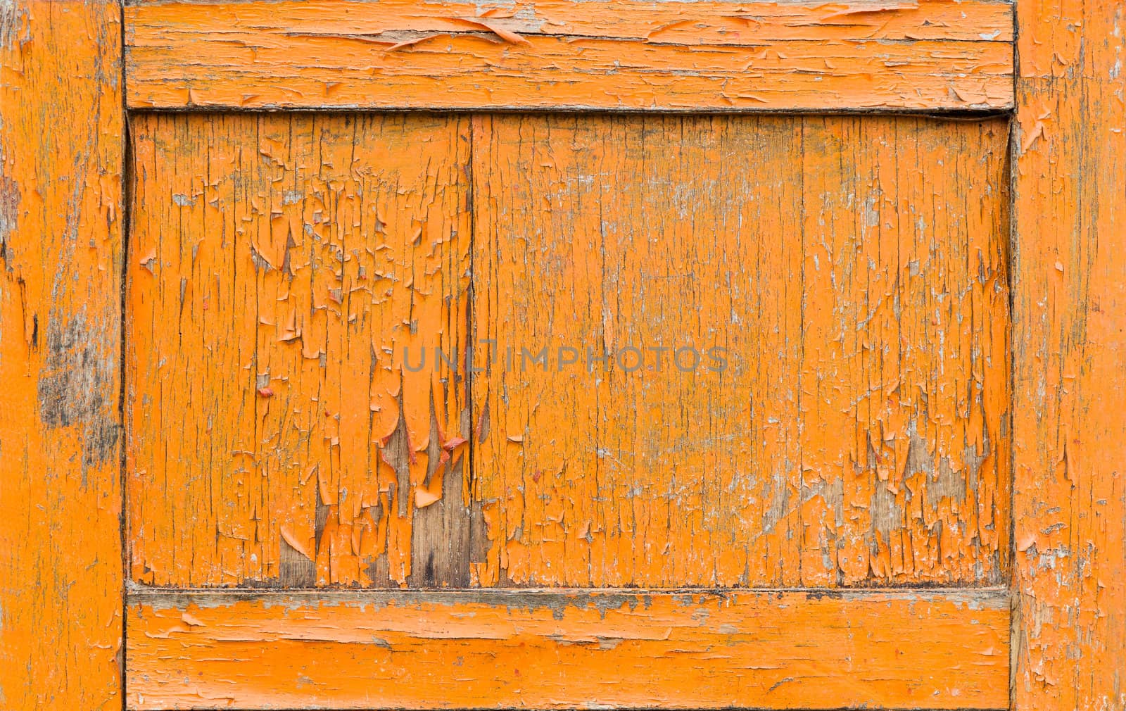 Cracked orange paint on old door