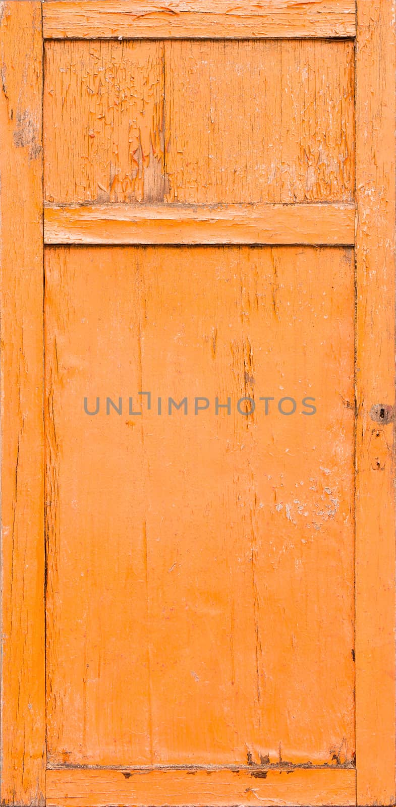 Old door with cracked orange paint