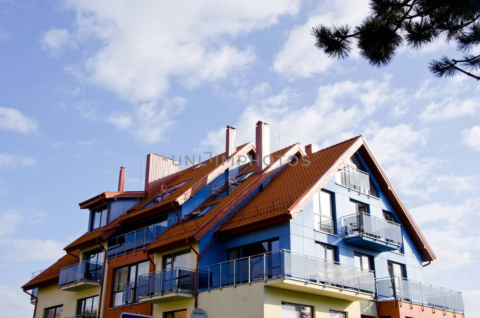 Modernist architecture building sunlit cloudy sky by sauletas