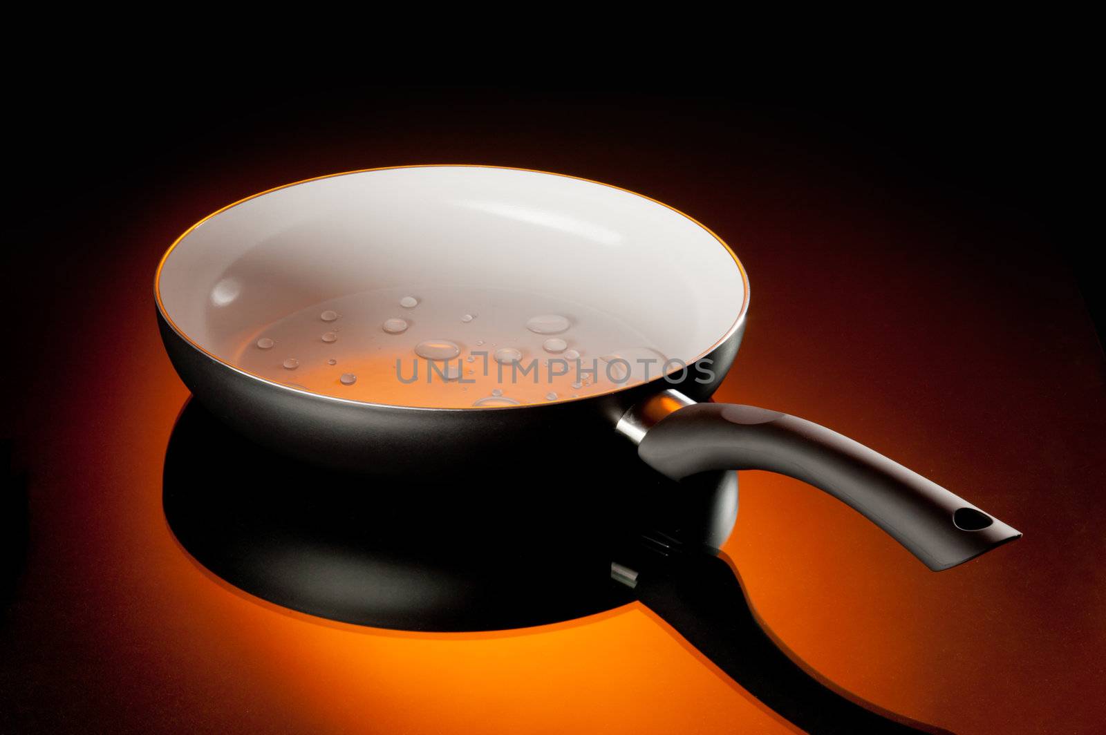 new ceramic frying pan over orange background