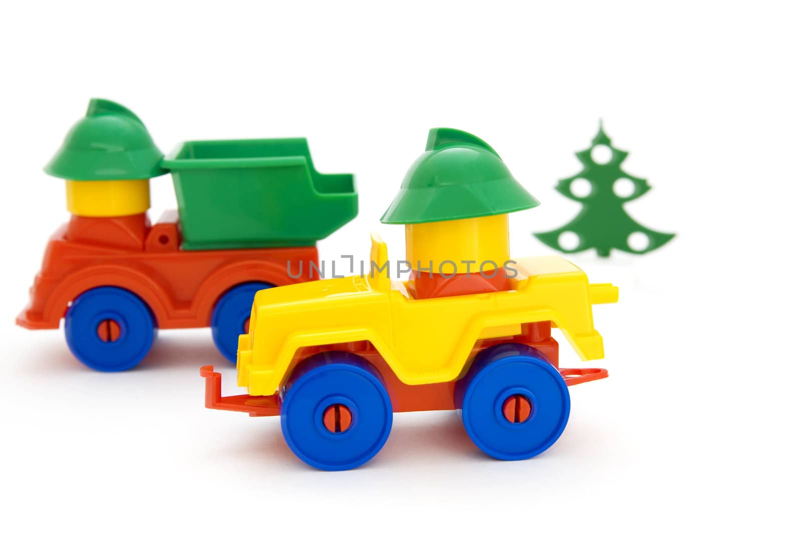 Bright toy cars and tree on a white background