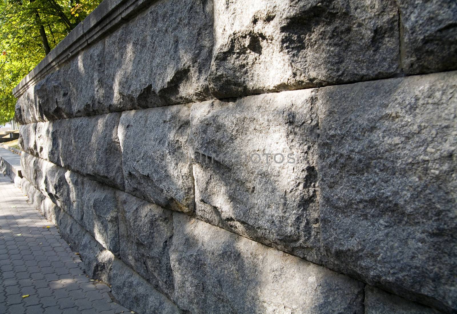 Old granite stone wall in city park