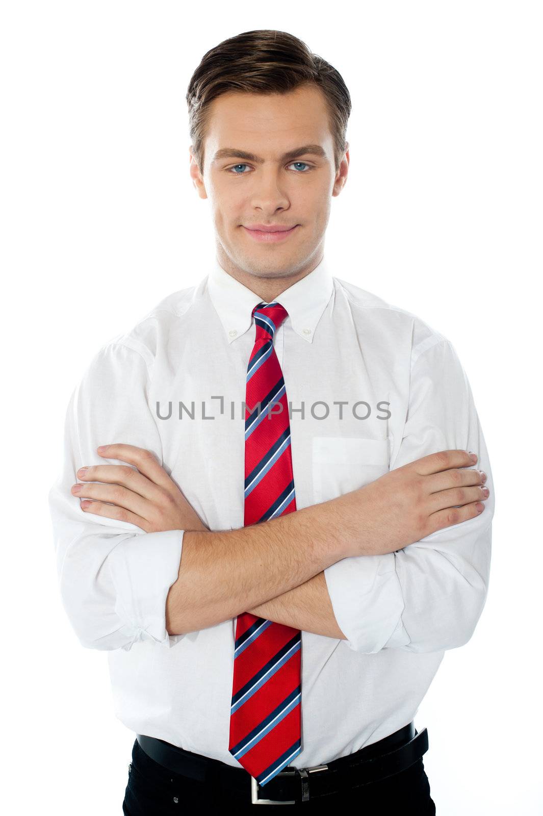 Cute young professional male standing with folded arms against white background