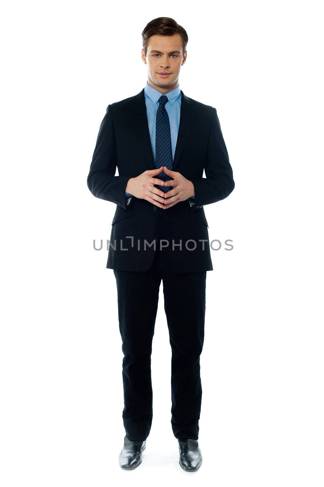 Smiling young confident executive by stockyimages