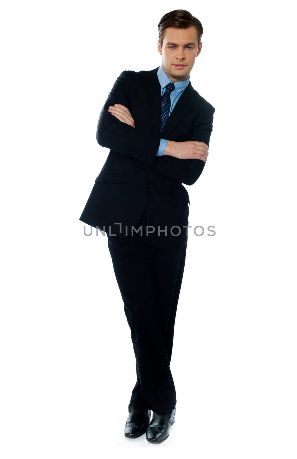 Handsome business executive tilting by stockyimages