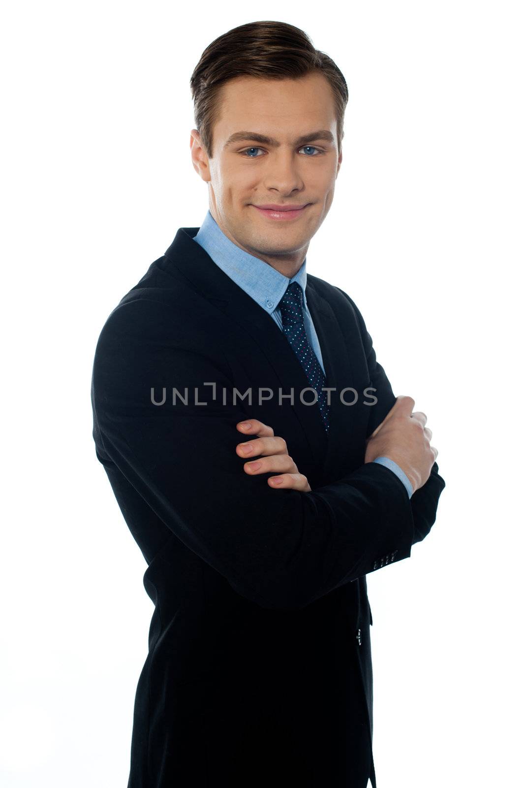 Charming young businessman posing in style by stockyimages