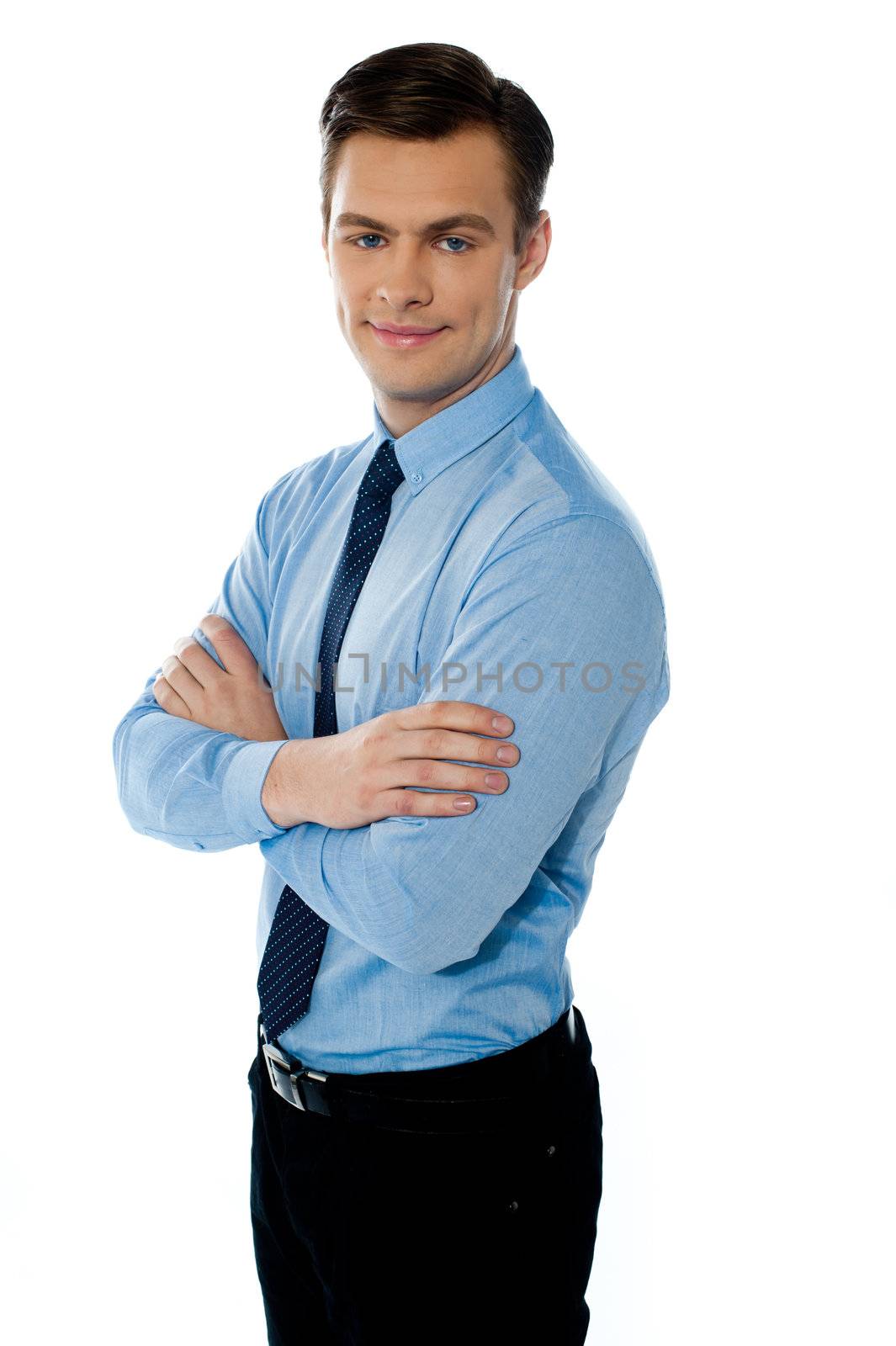 Executive standing isolated with folded hands and smiling at camera