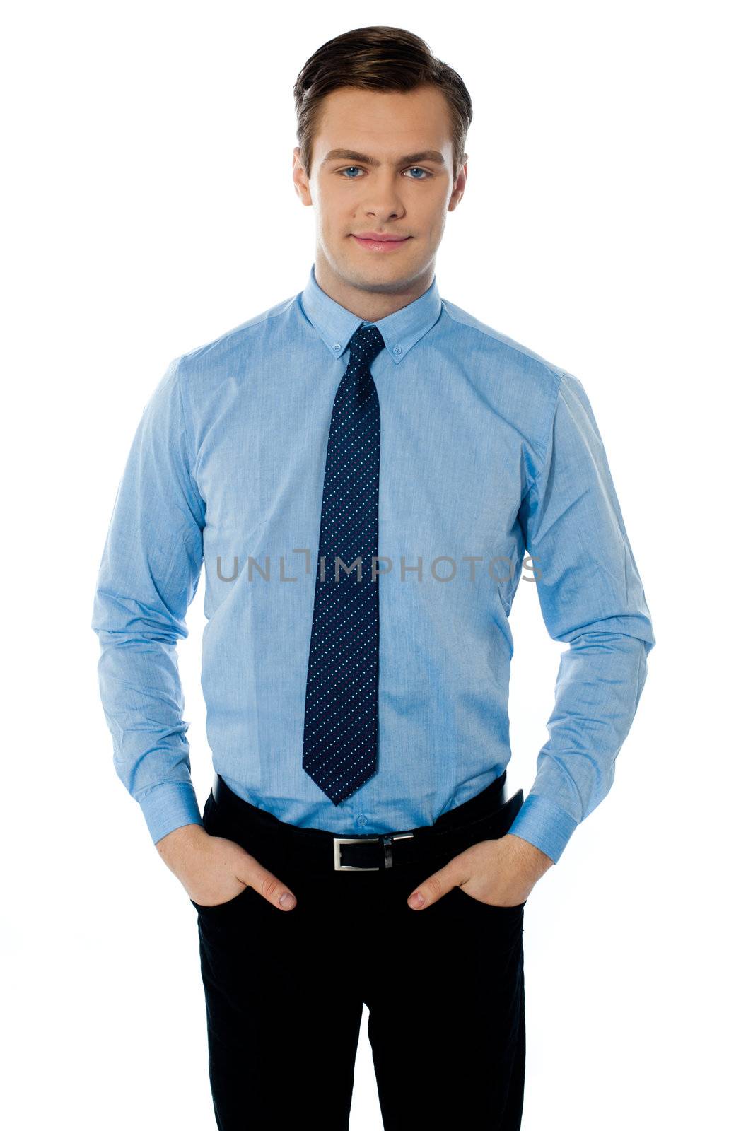 Businessman posing with hands in his pockets on white background