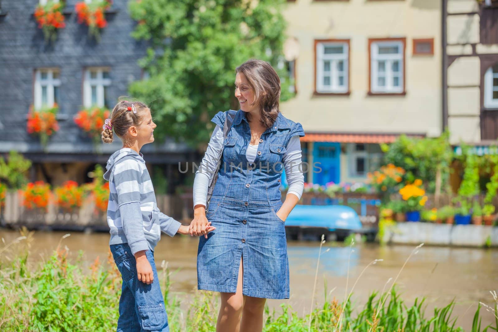 Tourists. Beautiful mother and daughter walking in europe city.