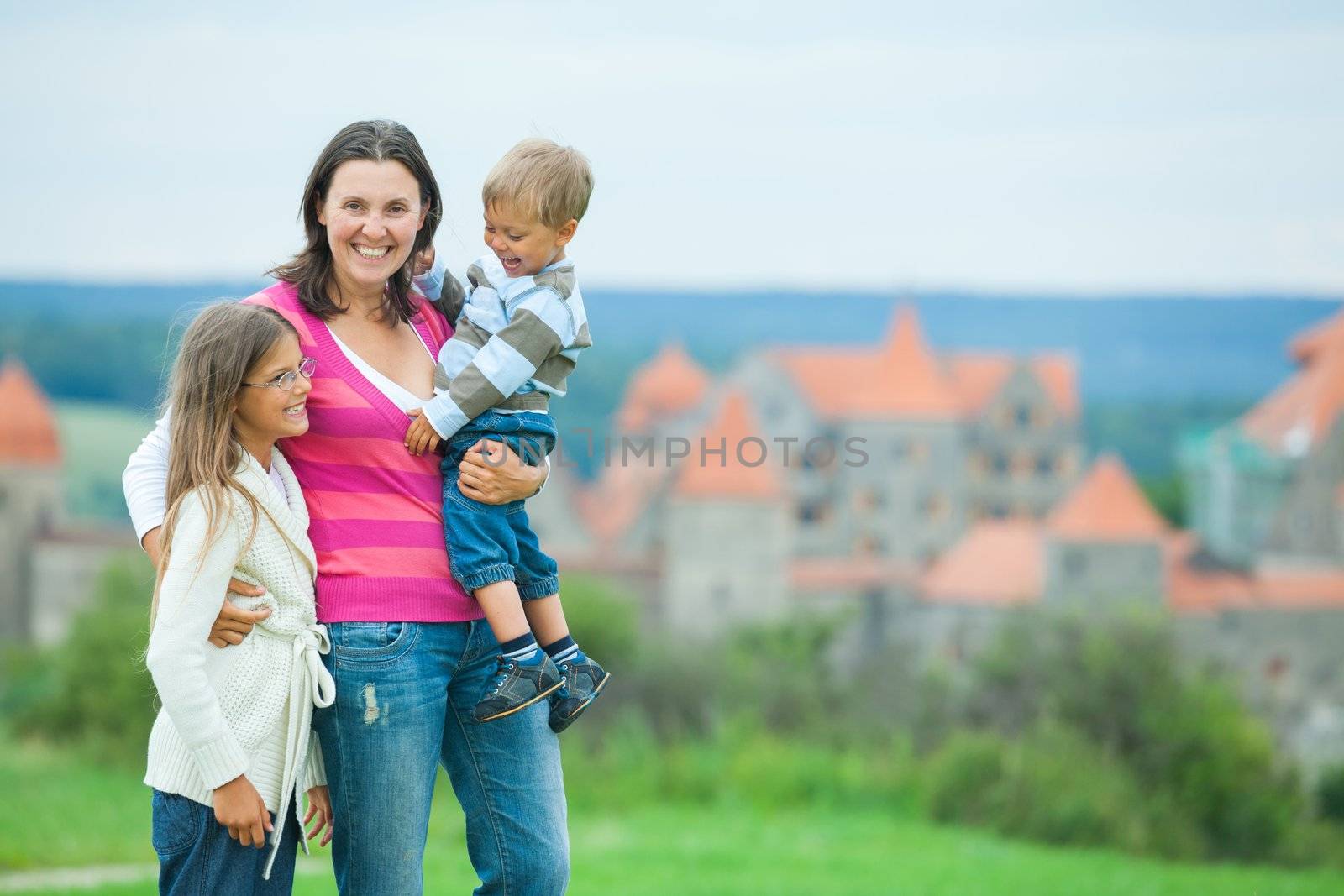 Travelers. Happy famyli of three on a tour of European medieval castles.