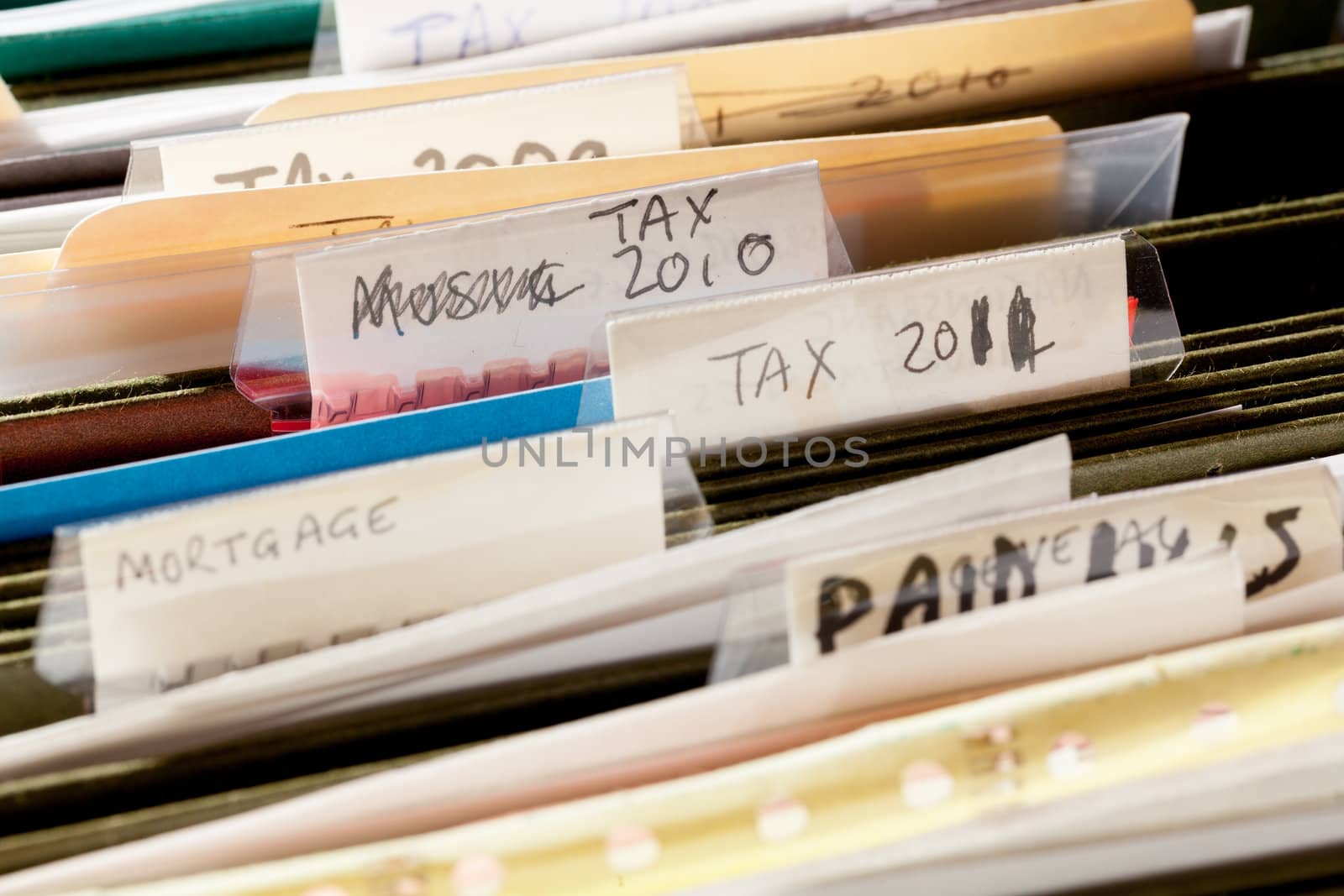 Folders in file drawer sorted into tax years and mortgage documents