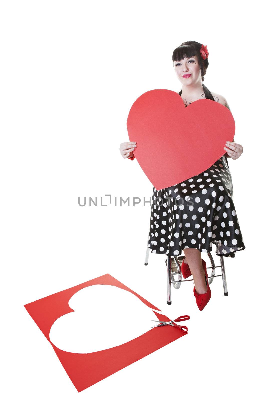 Valentine's day classic pinup girl pose, with a now rockabilly model.  Shot on white background.