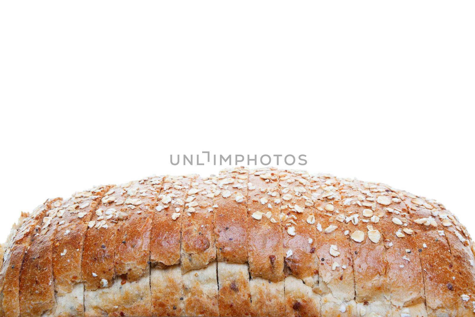 The top of a loaf of whole grain sliced bread.  Shot on white background.