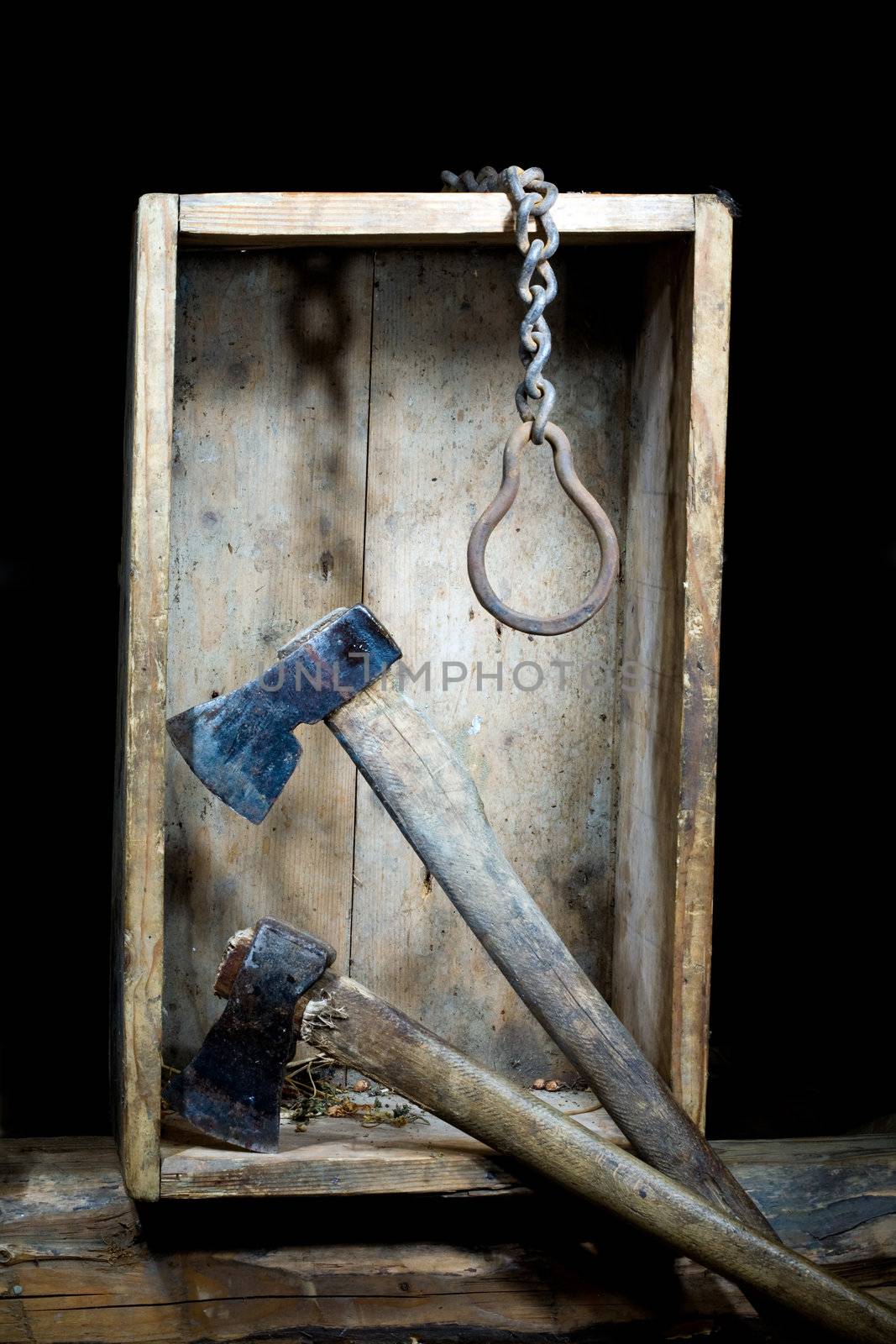 Stock photo: an image of two axes and metal chain  in a wooden box