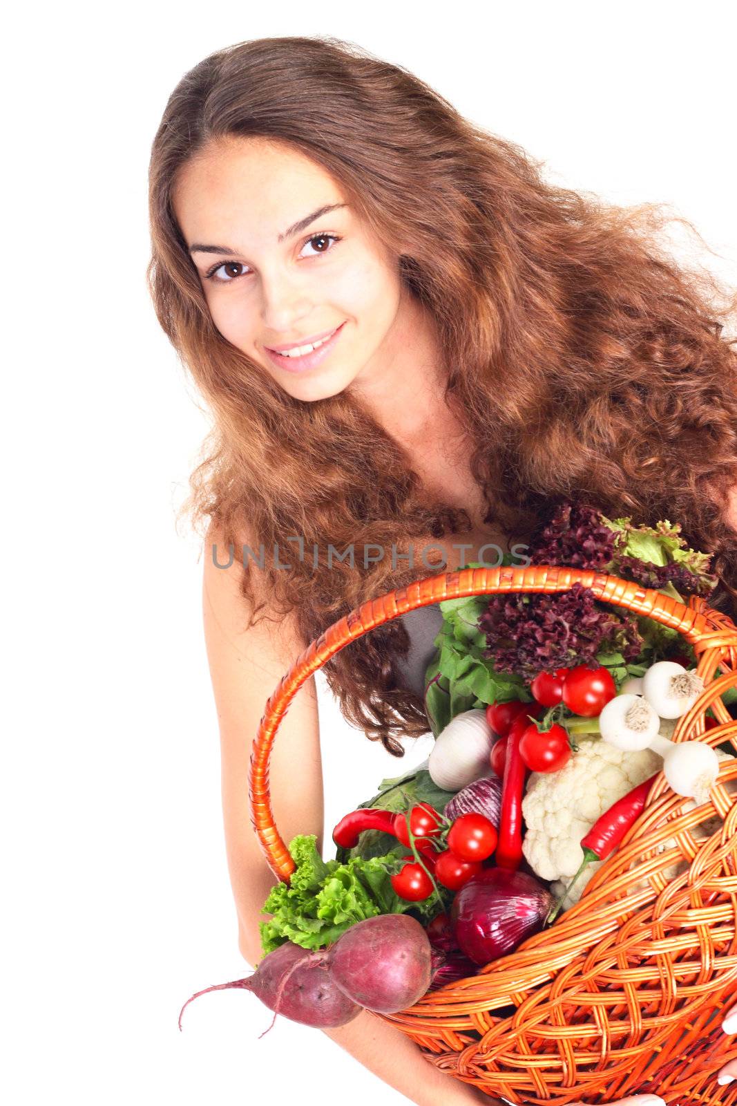 Young woman with basket of vegetables isolated on white background