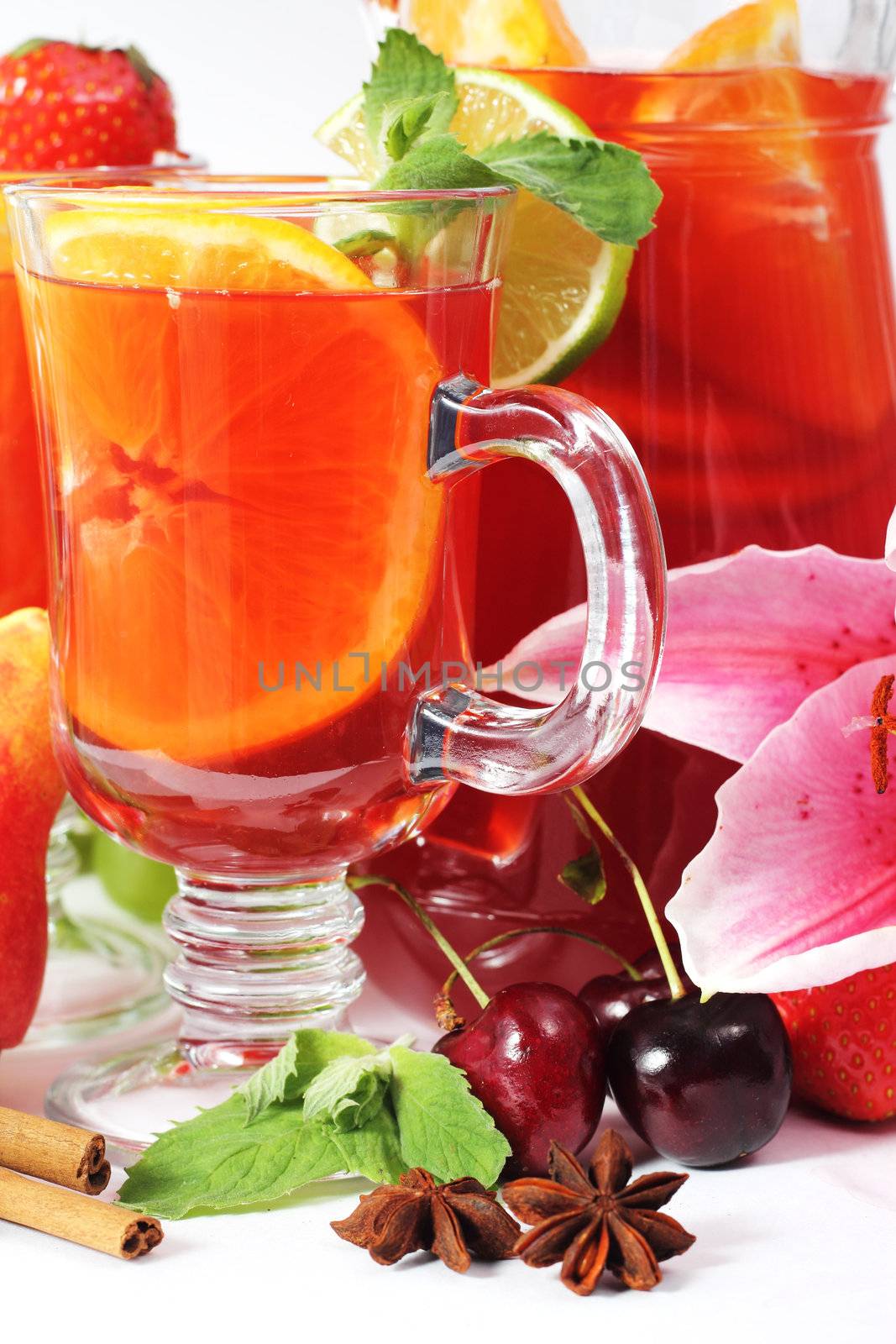 Refreshment beverage in glass with fruits and spice close-up