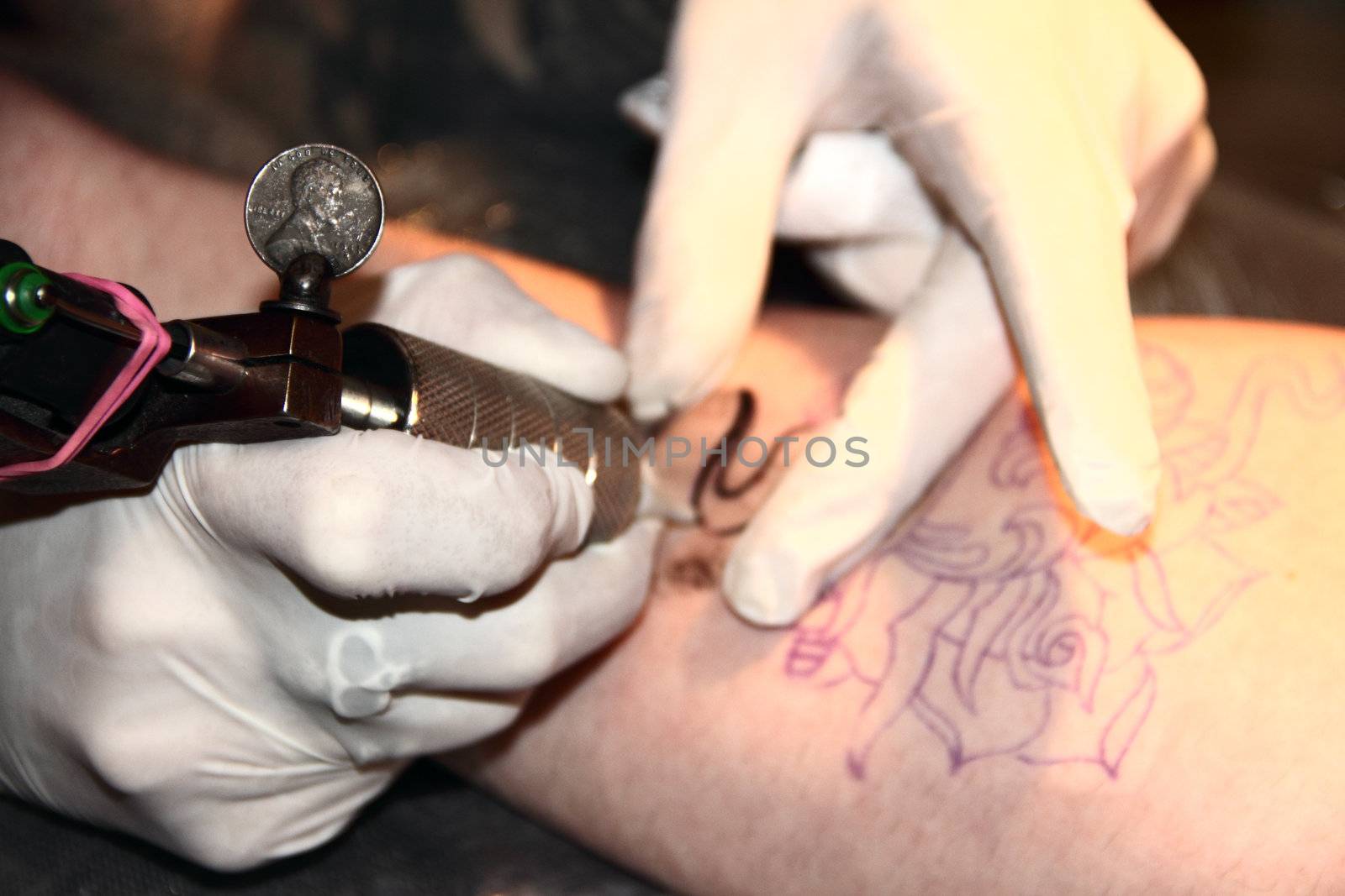 Making of tattoo on hand of caucasian man