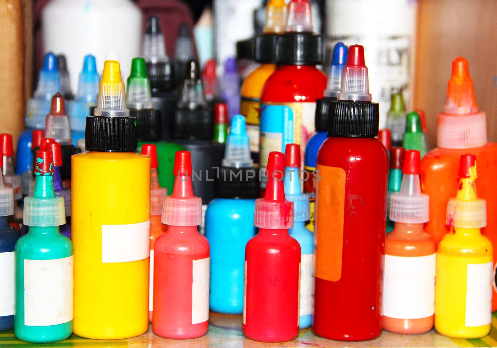 Collection of multicolored tattoo ink in bottles