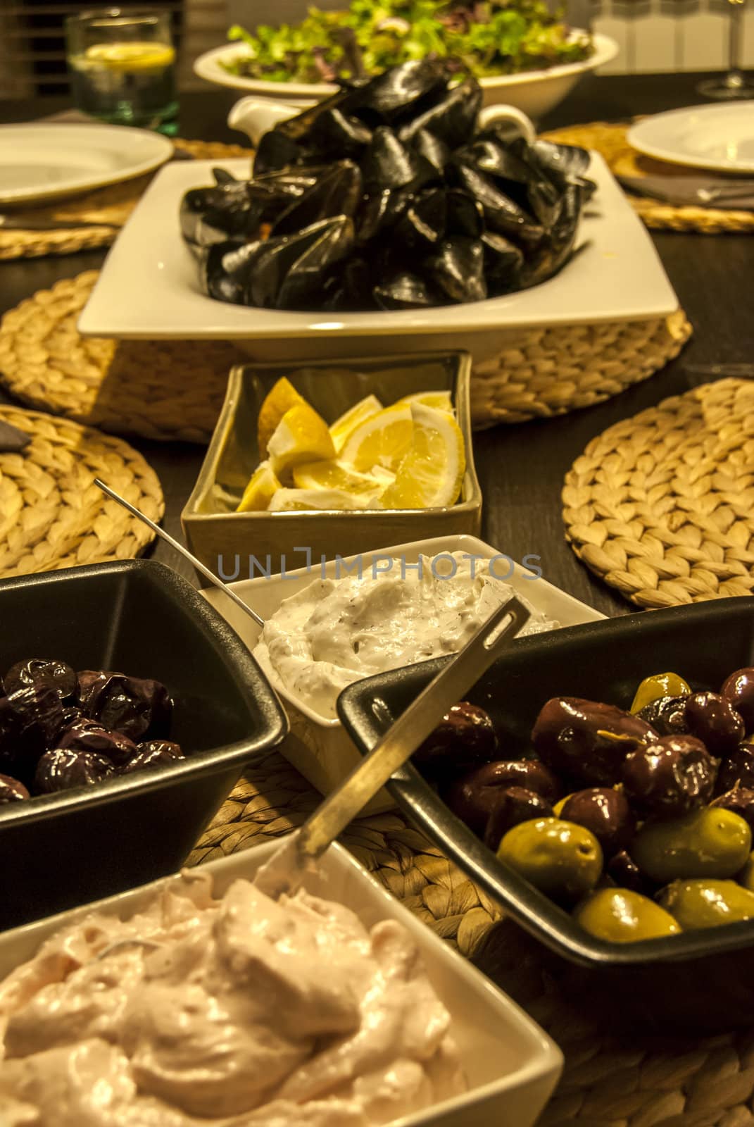 Table set with dishes with mussels, olives, caviar