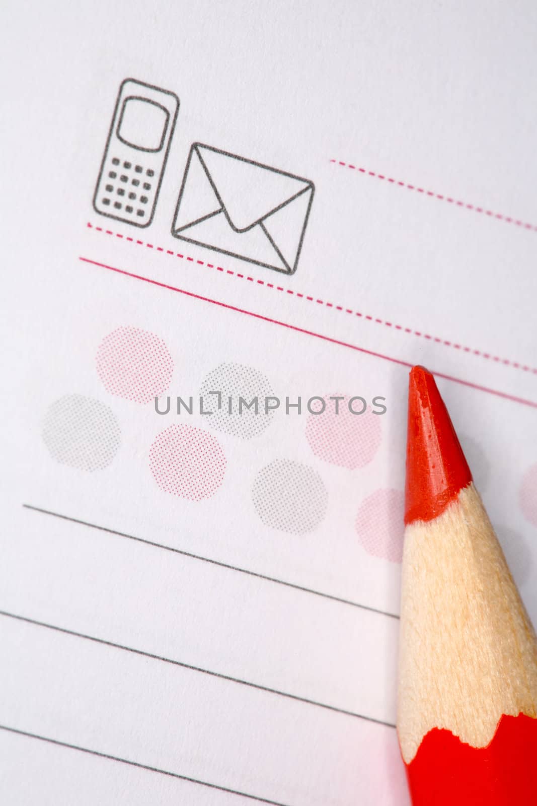 Closeup image of red pencil laying on notepad
