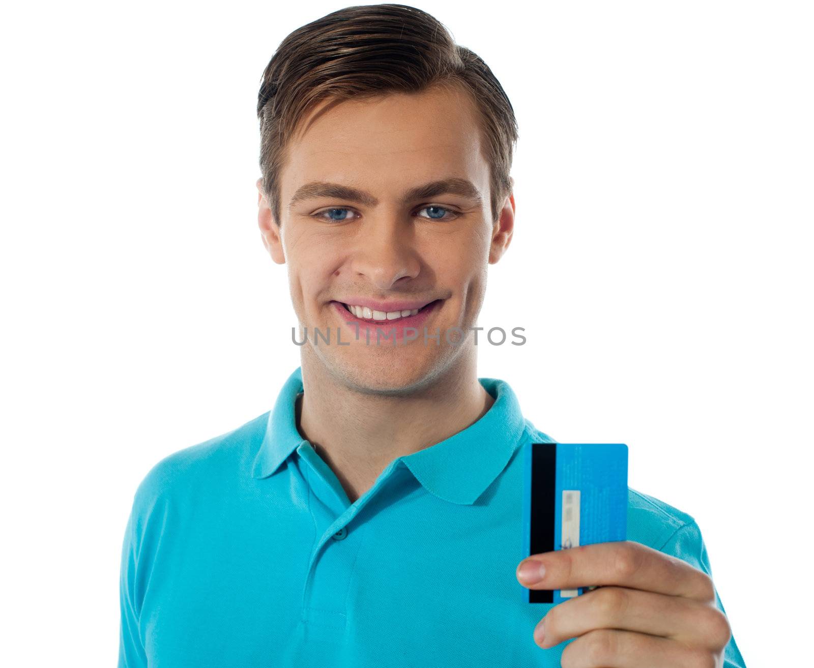 Fashionable young guy posing with debit card against white background