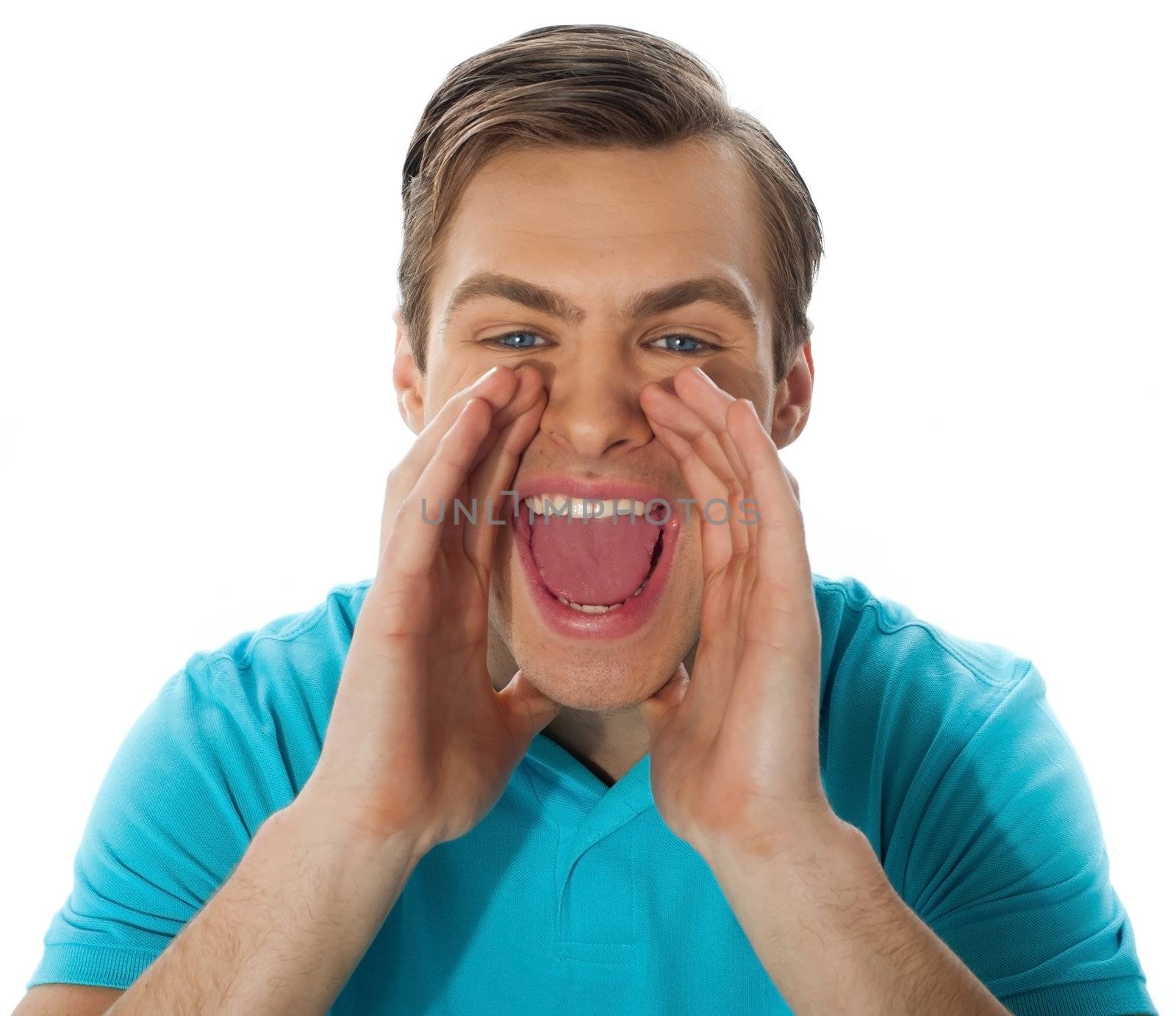 Young guy shouting loud against white background, closeup