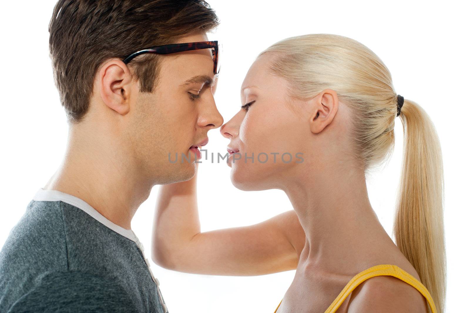 Closeup of couple kissing by stockyimages