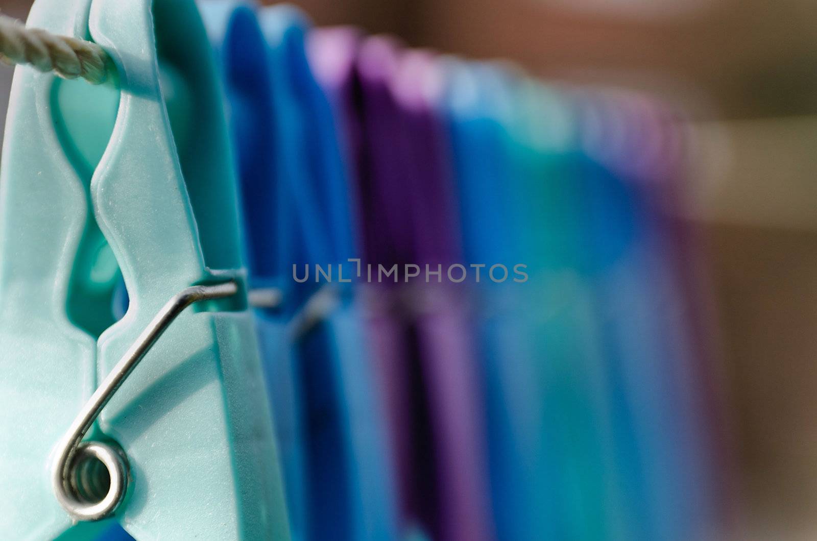 Coloured clothes pegs on a washing line