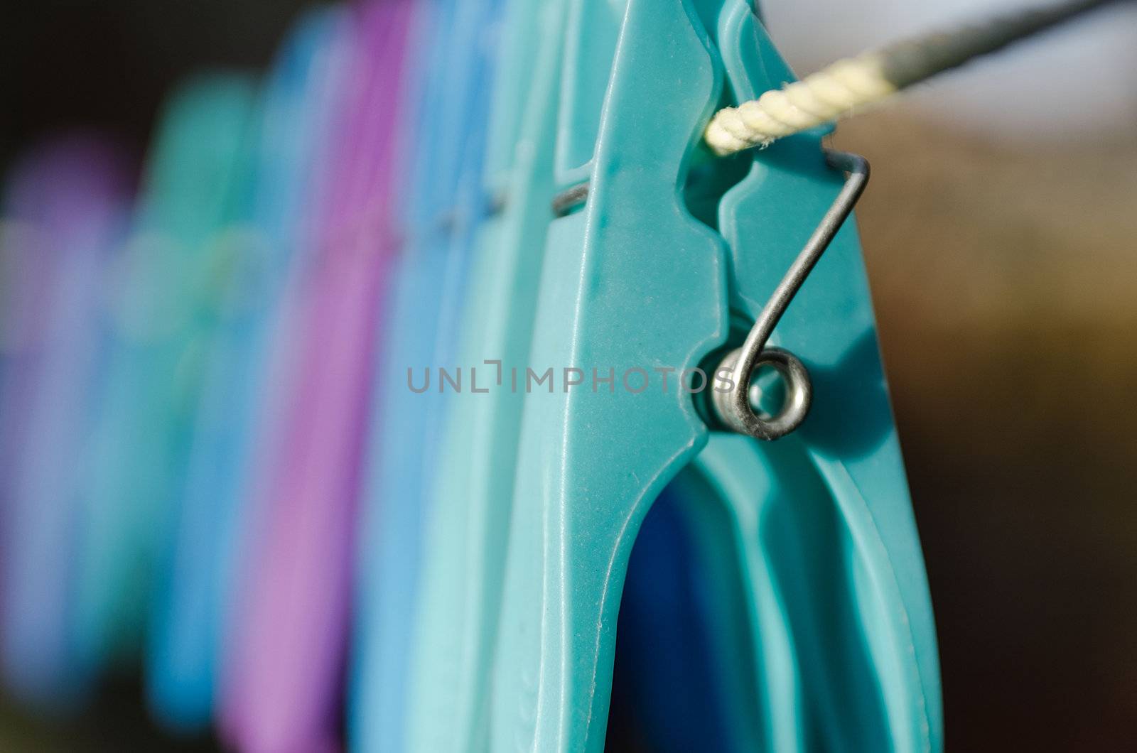 Colourful clothes pegs on a washing line