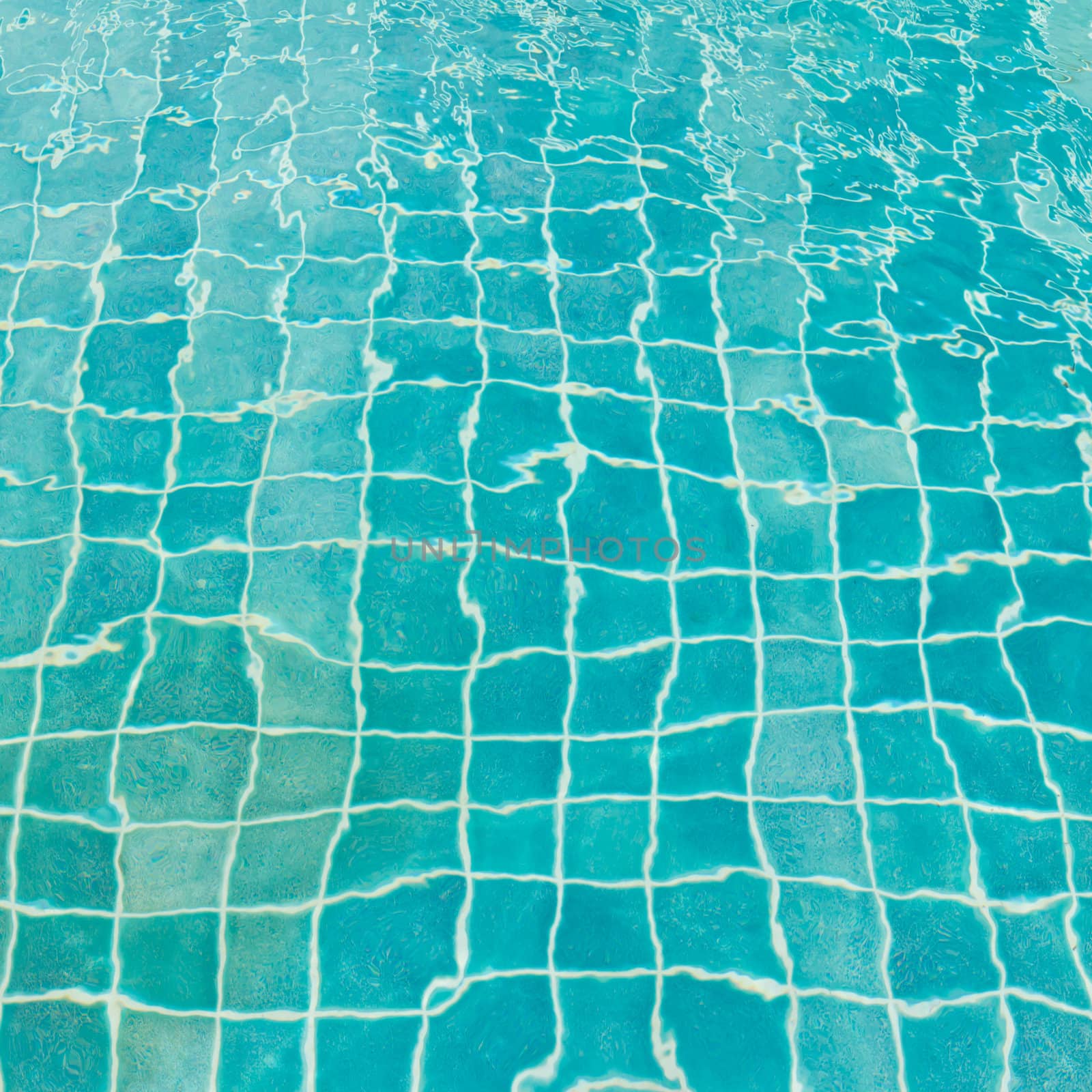 aqua blue tile in pool by tungphoto