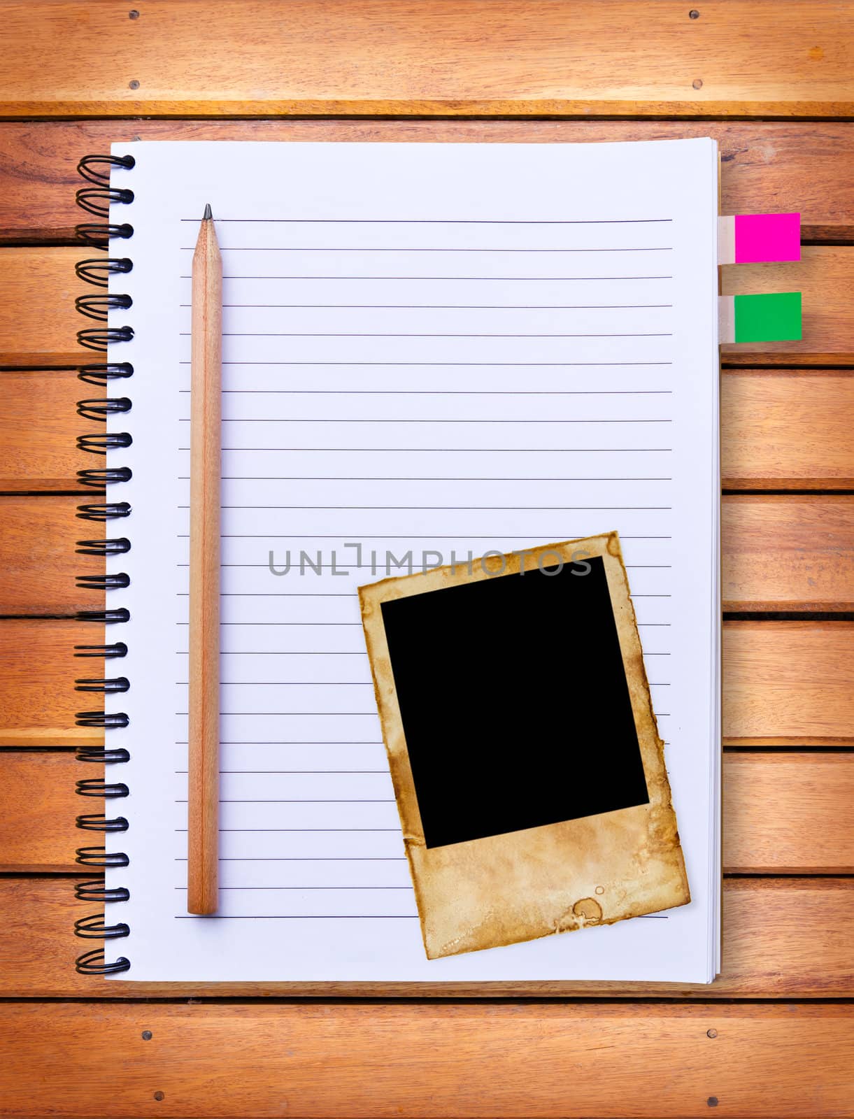 notebook and vintage photo frame on wood background by tungphoto