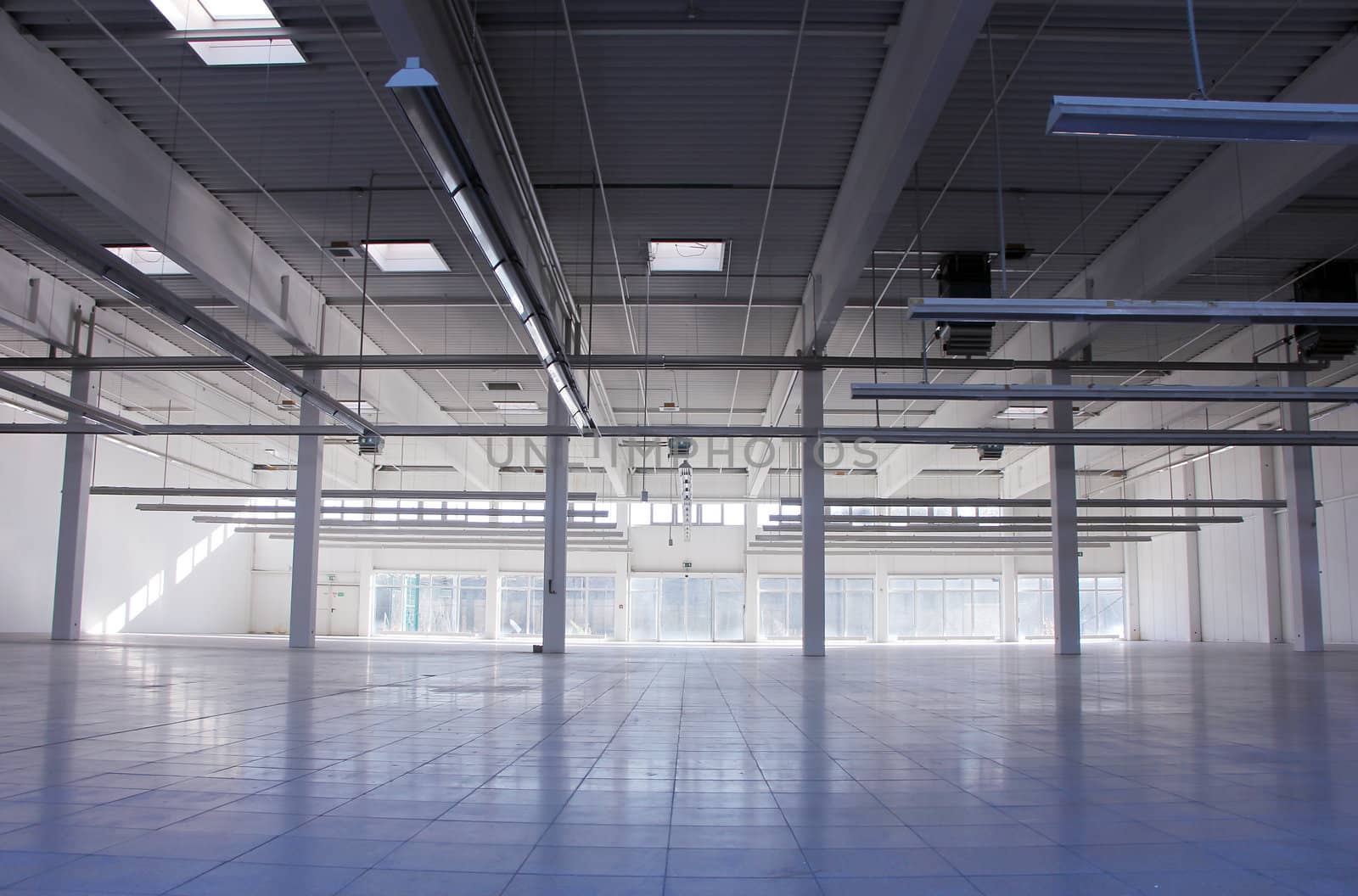 big empty industrial hall with headlights on the ceiling