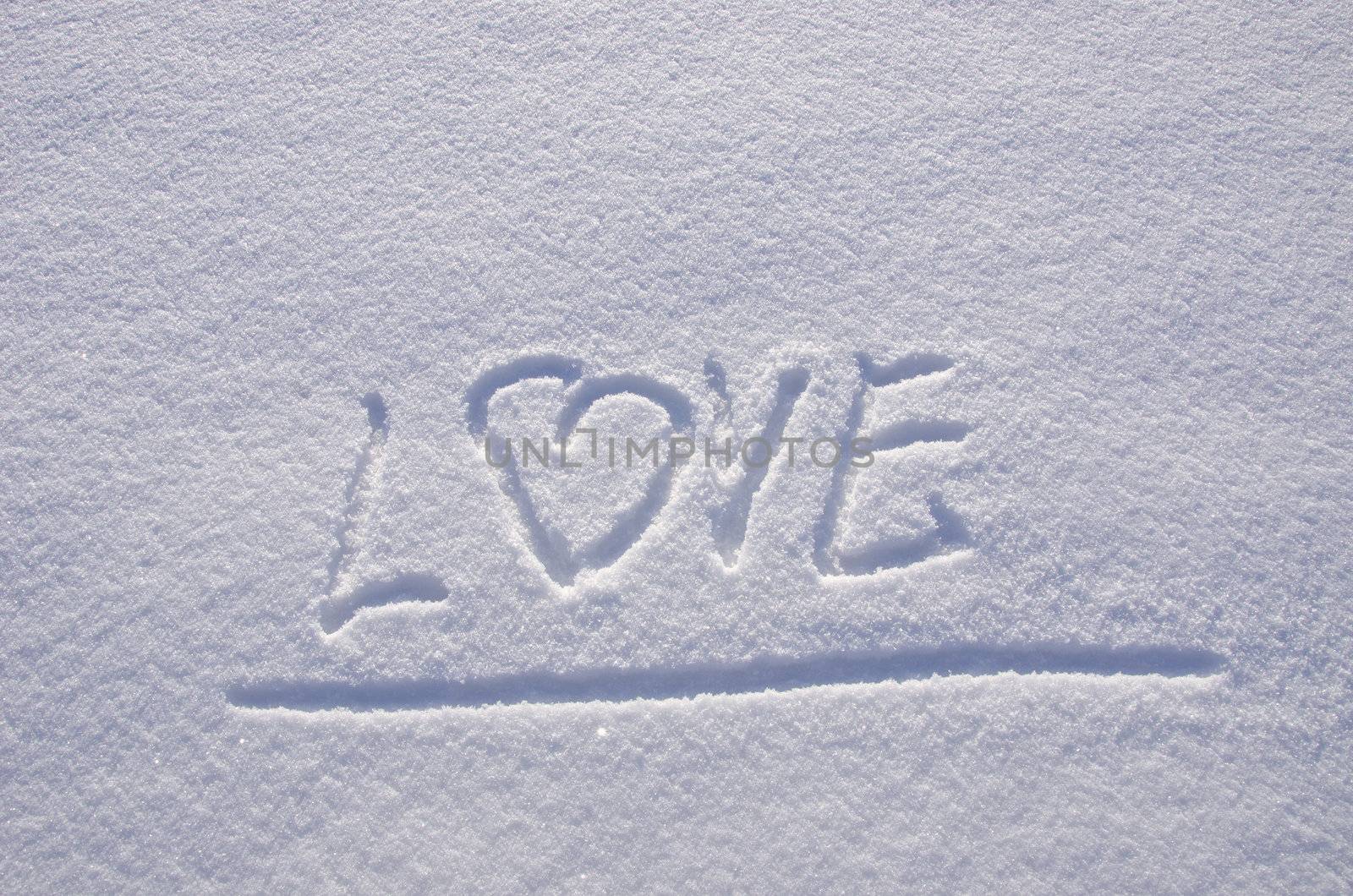 Inscription love on snow in winter. Concept expression of human feelings.