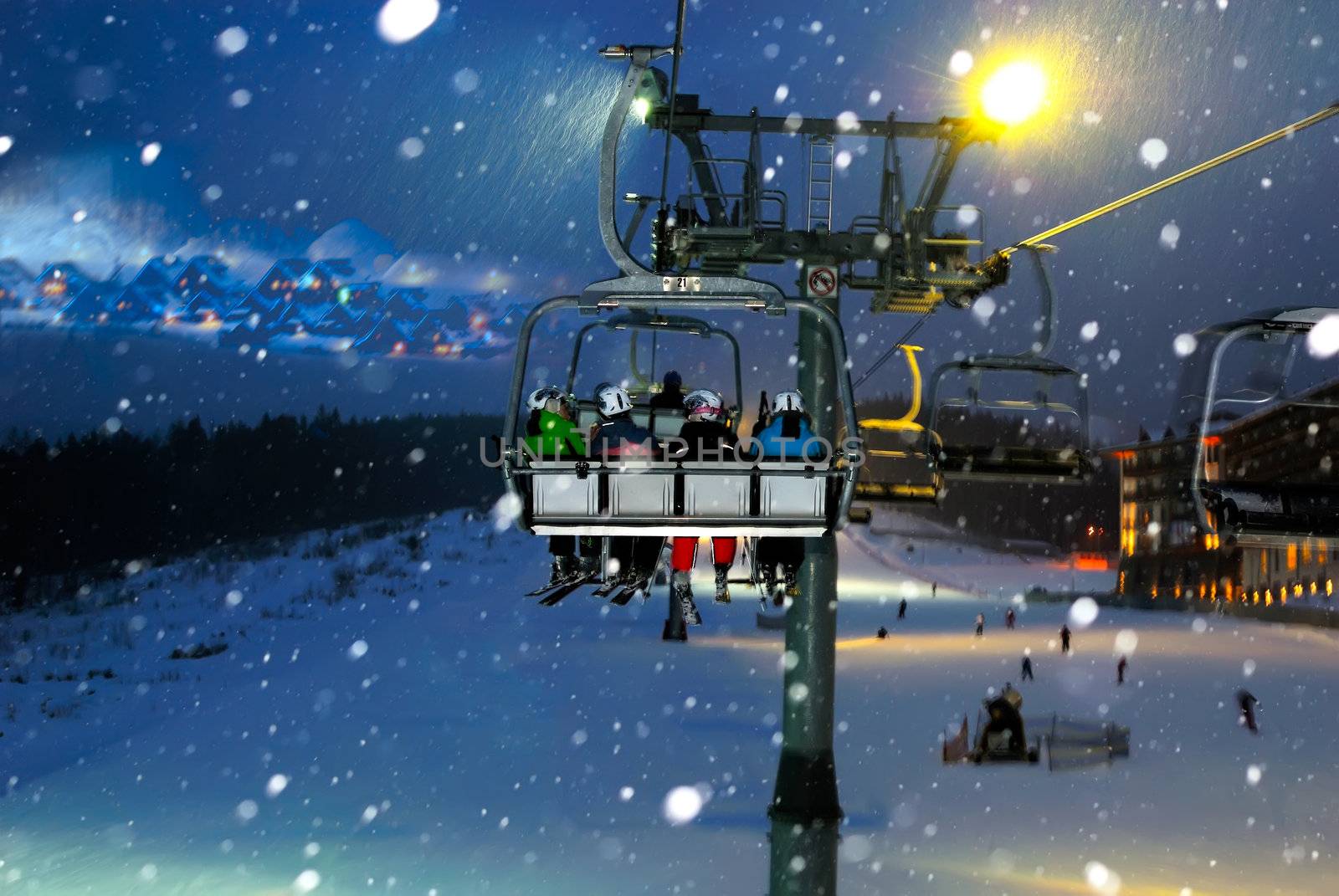 people ride in the chair lift, elevator, night landscape