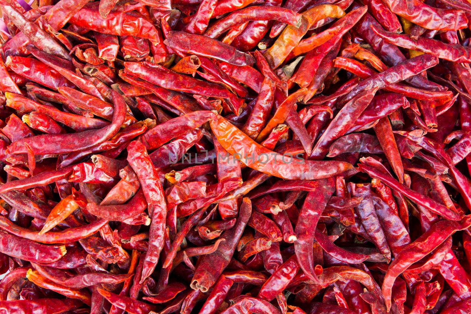pile of dried chilies by tungphoto