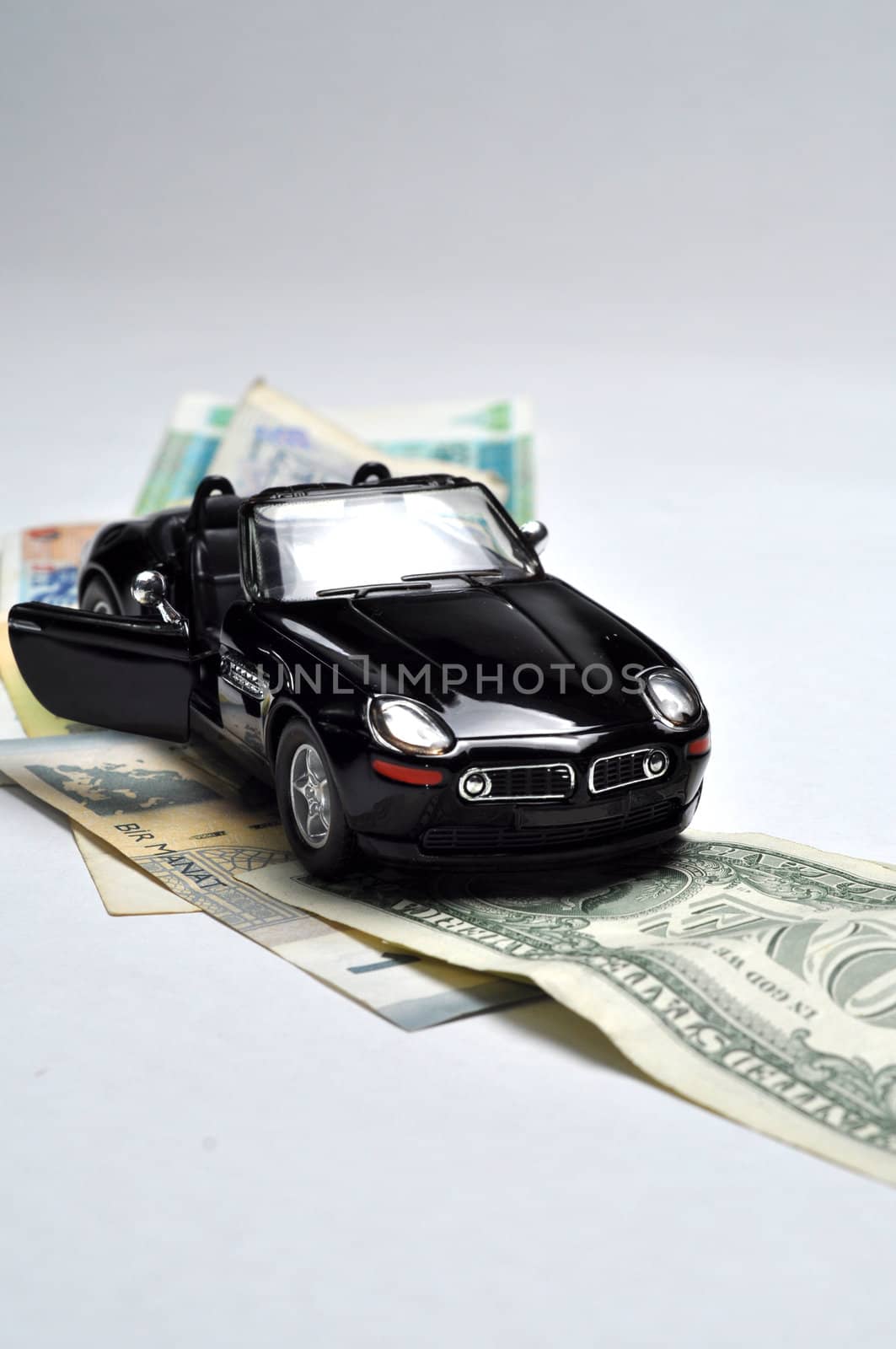 Black sport car and money on white