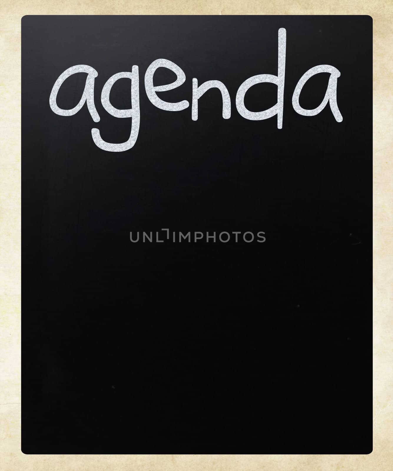"AGENDA" handwritten with white chalk on a blackboard