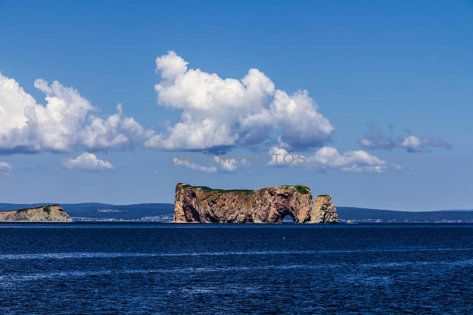 Perce Rock in a sunny day in Saint Lawrence river in Gaspesie, Quebec, Canada